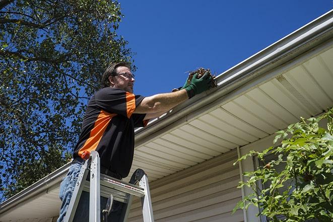 neighborhood handyman repairing rain gutters in Chesterfield MO